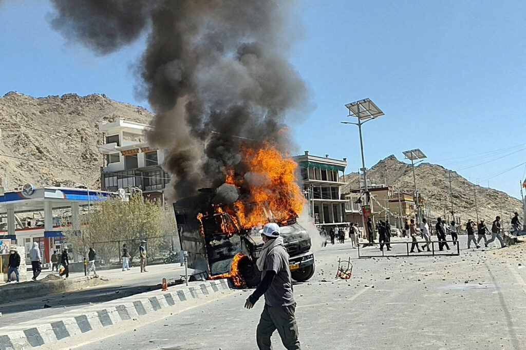 A vehicle is set on fire during a protest by locals demanding statehood for the federal territory and job quotas for local residents in Leh