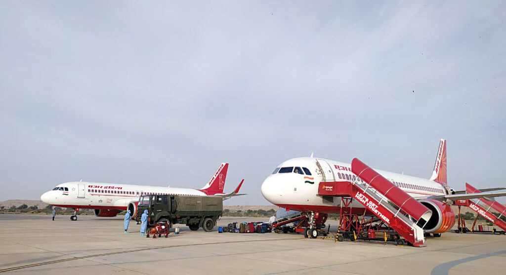 Luggage being taken out from the Air India Flight as evacuees from Iran arrived at Airport